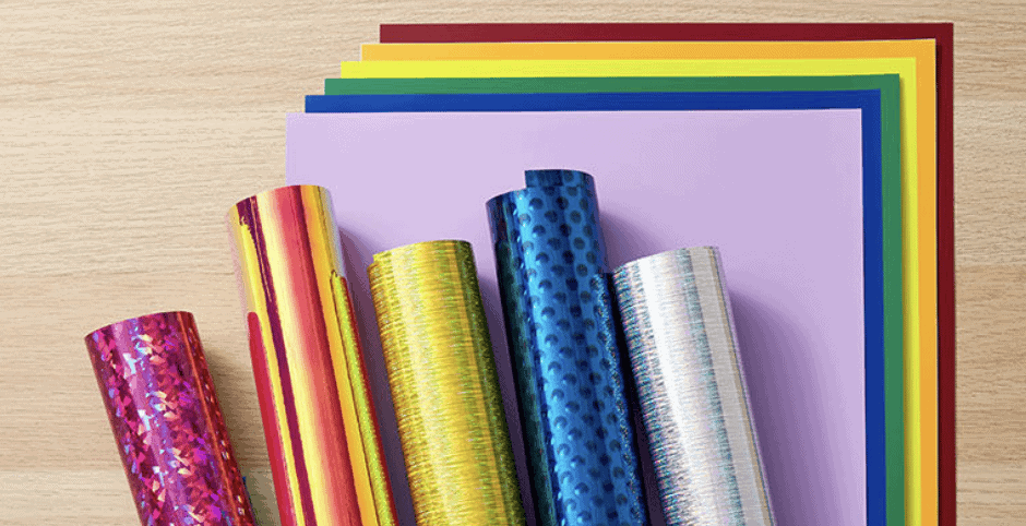 rolls of cricut vinyl displayed on a craft table