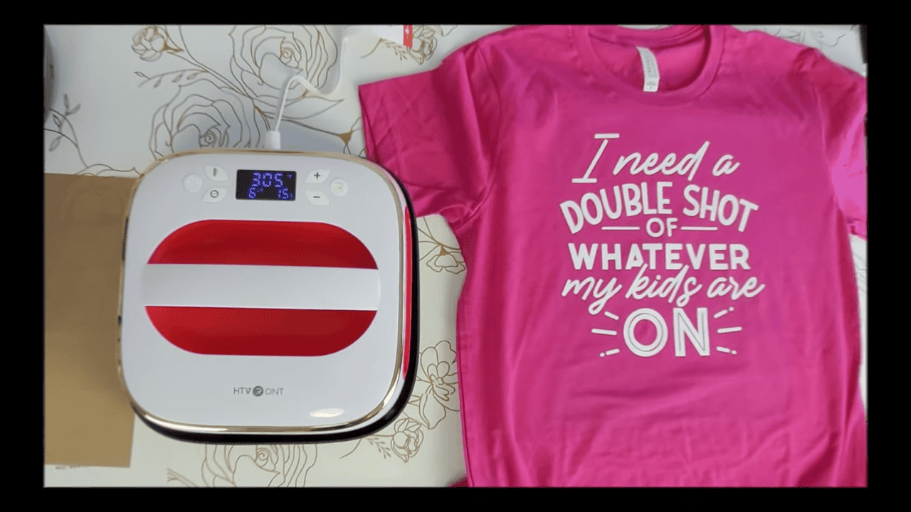Finished pink t-shirt reading I need a double shot of whatever my kids are on, next to the heat press