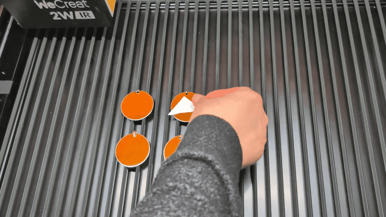 Four stainless steel keychain blanks placed inside the Vista laser