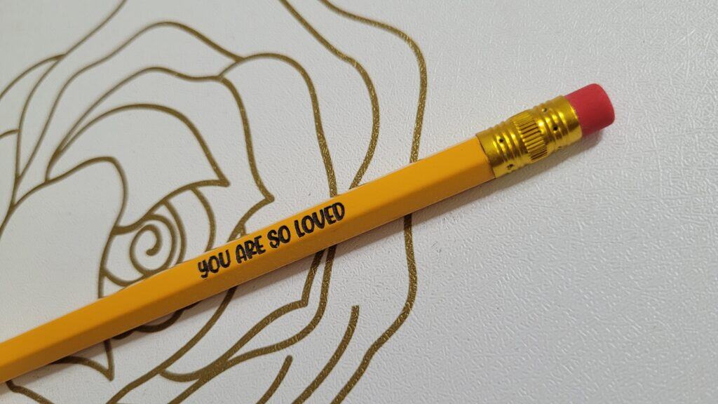 Laser engraved yellow pencil with the text “You Are So Loved” created using WeCreat Vista