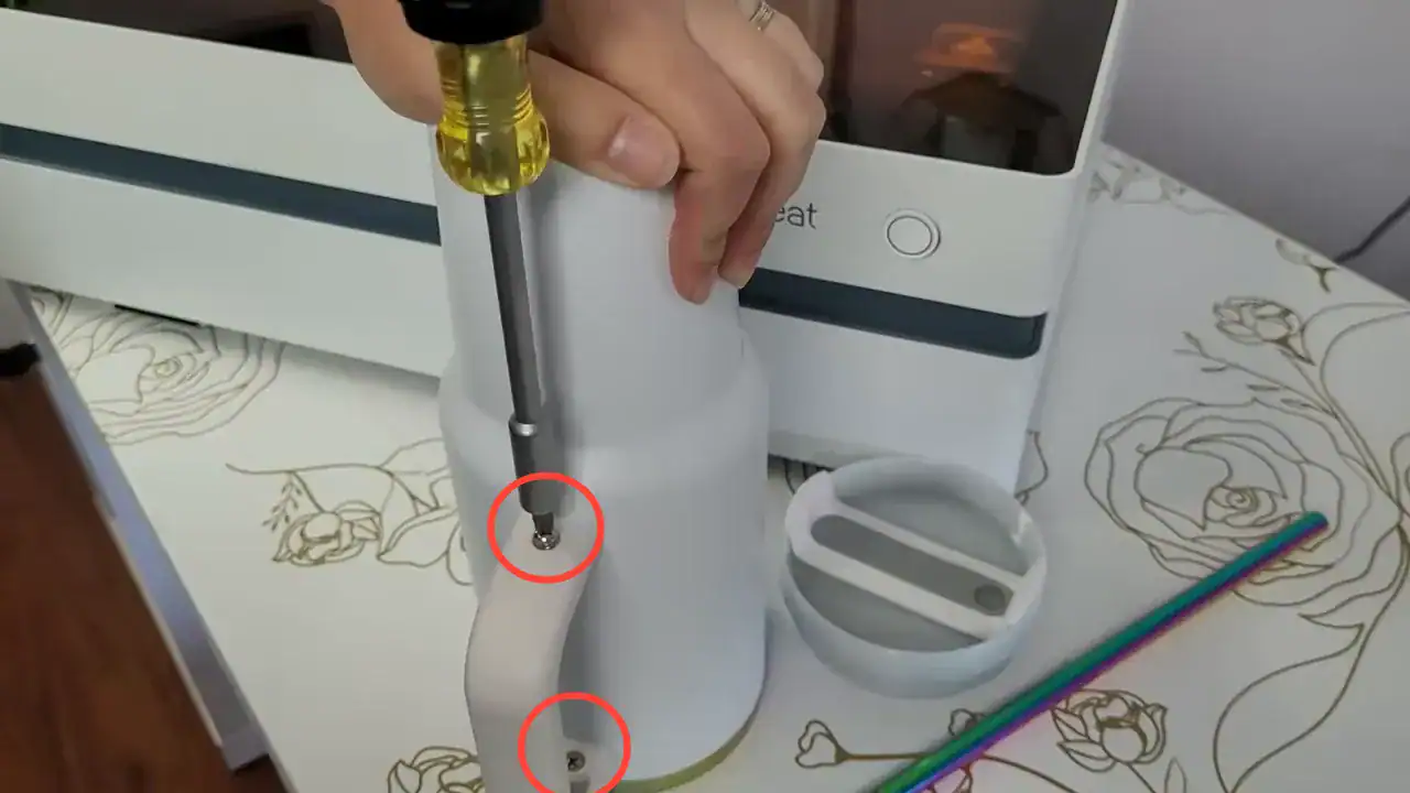 Unscrewing and removing the handle from a 40oz tumbler before engraving on the WeCreat rotary attachment