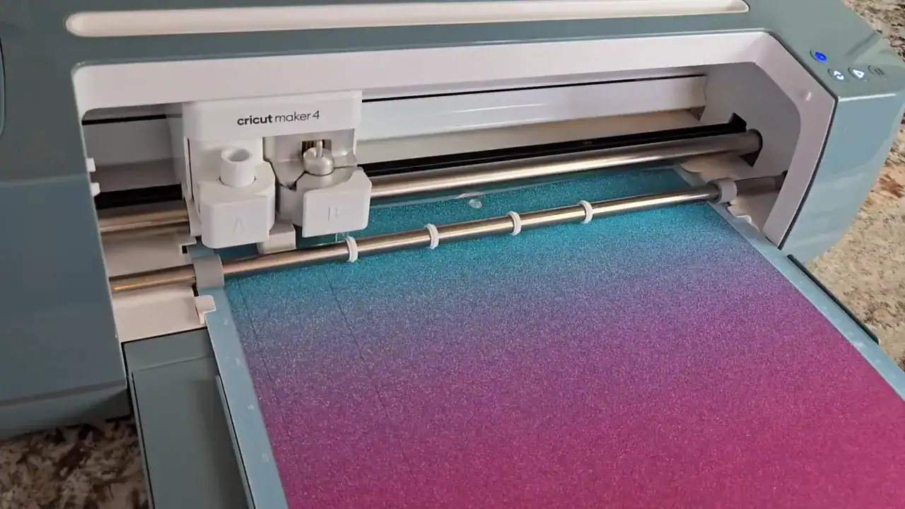 Cricut Maker 4 machine with pink-gold gradient glitter cardstock loaded on LightGrip cutting mat ready to cut DIY bookmarks
