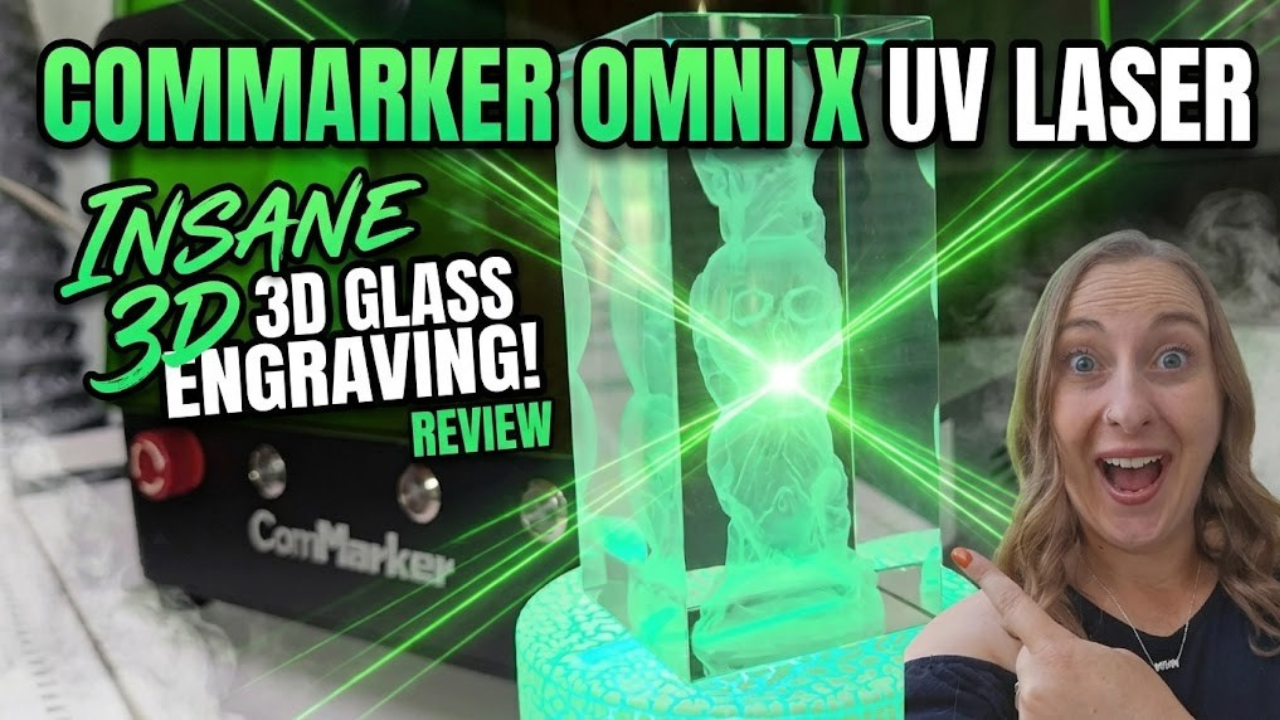 YouTube thumbnail featuring Kerri Adamczyk with an excited expression pointing at a 3D laser-engraved glass crystal block displaying an owl design. A ComMarker UV laser machine is visible on the left. Text overlay reads "ComMarker Omni X UV Laser" at the top, with "Insane 3D Glass Engraving! Review" on the left side. Green laser beam effects accent the image.