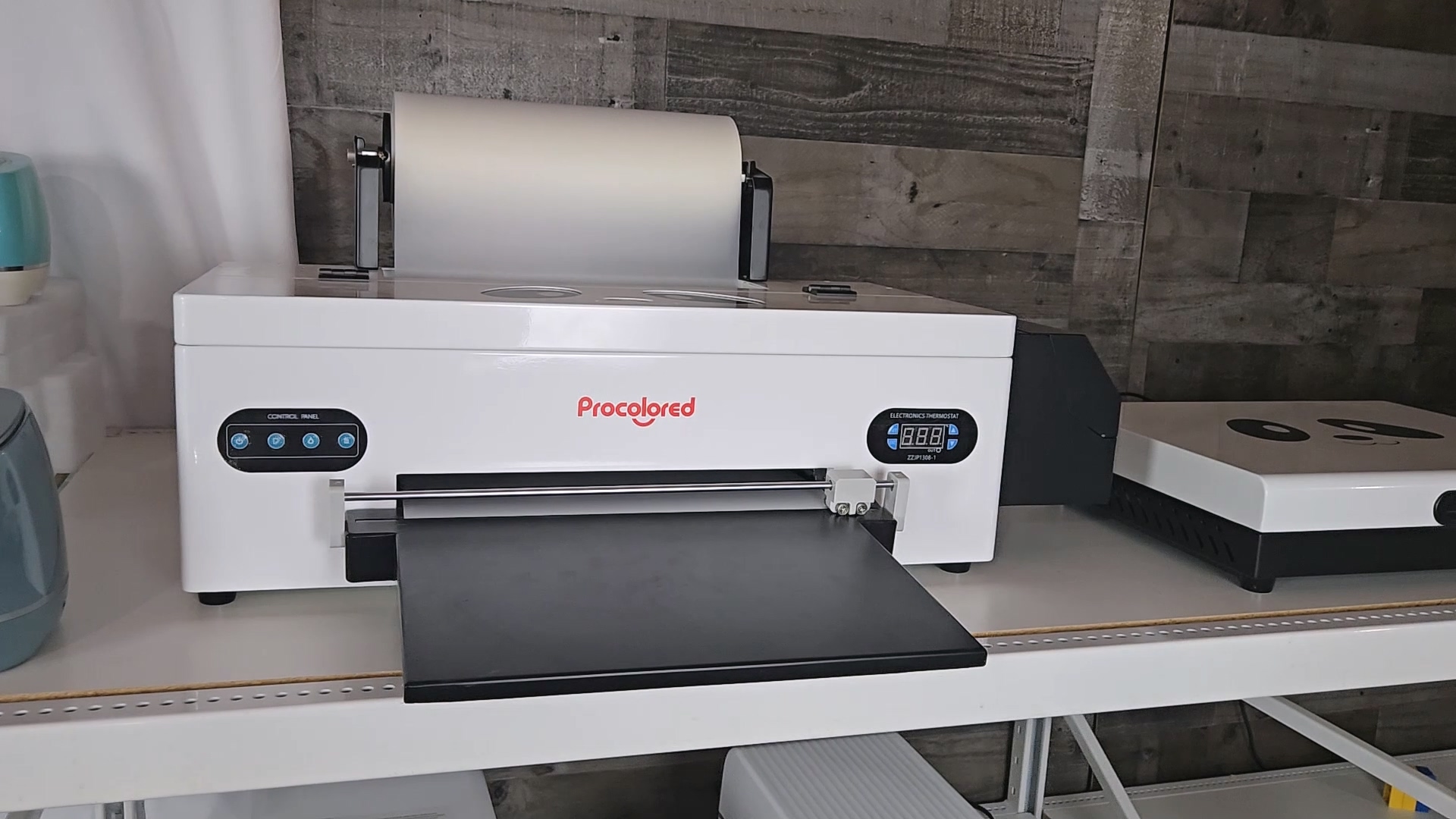 Procolored F13 Panda DTF printer with roll film holder on white table in craft room, showing digital display and control panel