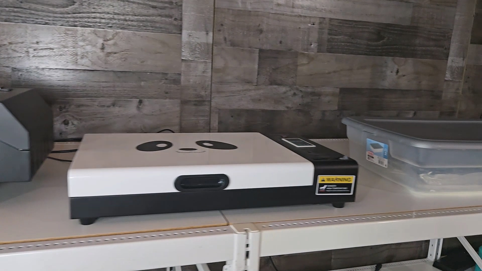 Procolored smokeless curing oven with panda face design on top, sitting on craft room shelf next to storage container