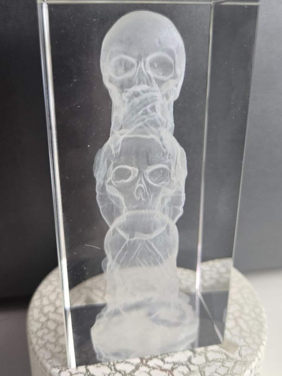 Skull design engraved inside 3D crystal glass cube on lighted LED display base
