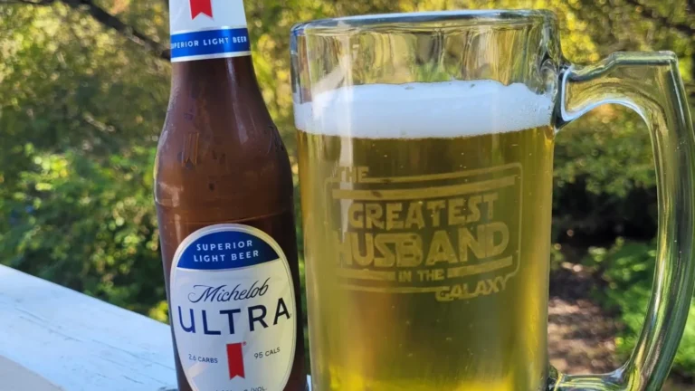 Beer mug etched with a Cricut reading The Greatest Husband in the Galaxy, filled with beer beside a Michelob Ultra bottle