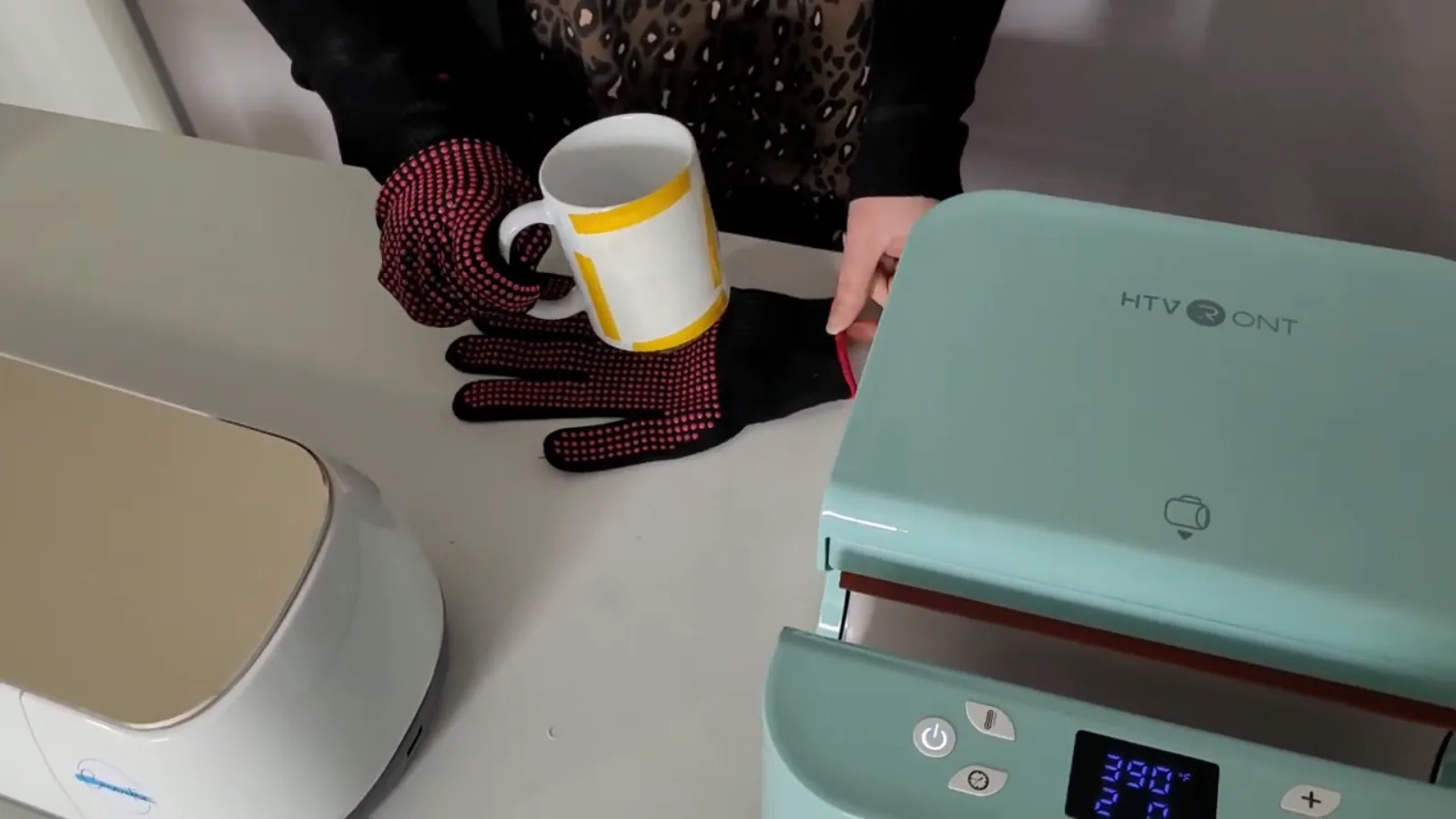 Hot sublimated mug resting on a heat resistant glove to cool after pressing