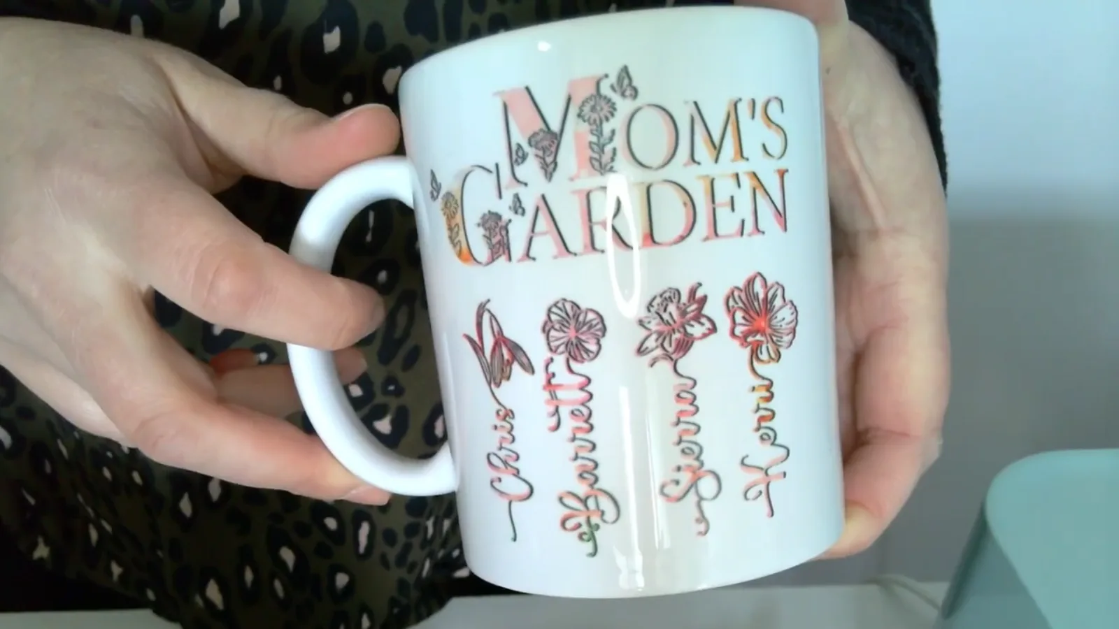 Finished sublimated coffee mug with a full colour personalized birth flower design