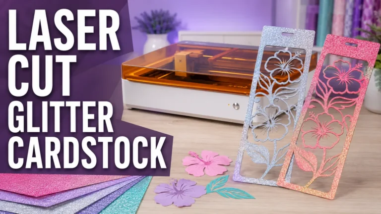 Two laser cut glitter cardstock hibiscus bookmarks in silver and pink beside the xTool M2