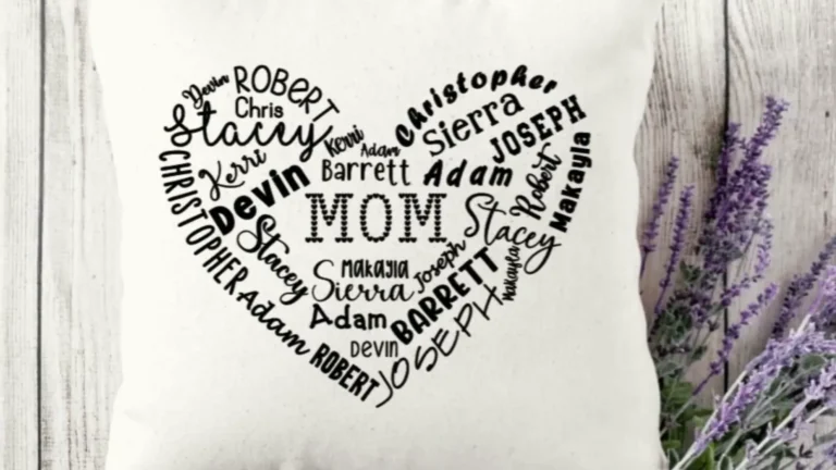 Heart-shaped pillow made with a Cricut showing family names in many different Cricut fonts