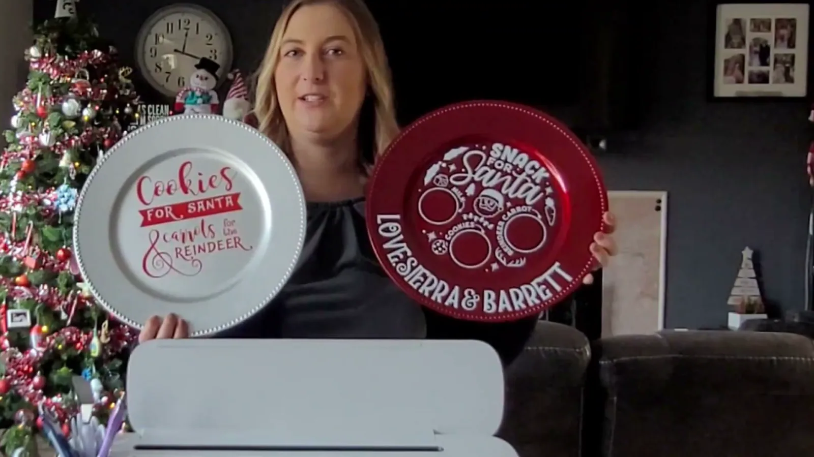 Two finished Cricut Christmas plates, one silver reading Cookies for Santa and one red personalized with kids names