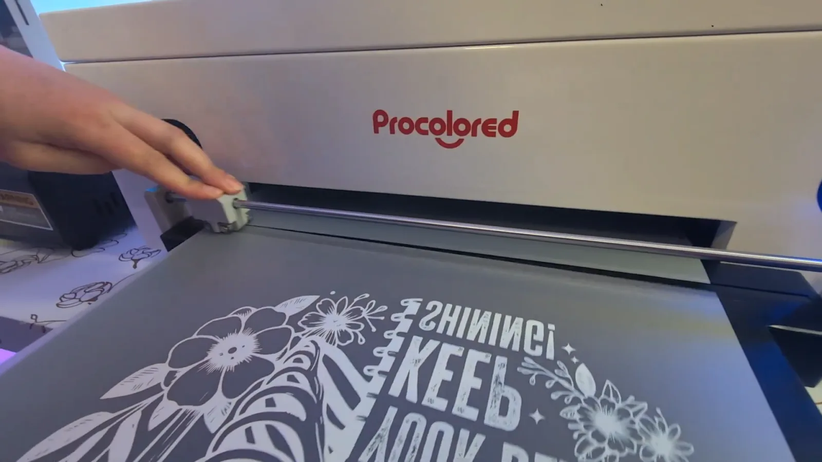 A Procolored DTF printer printing a mirrored design onto clear transfer film
