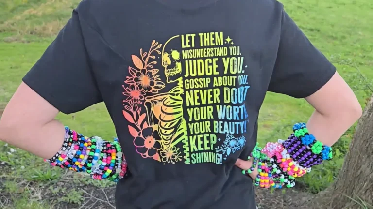 Bright rainbow floral DTF design printed on a charcoal grey t-shirt, showing full color DTF printing on a dark shirt