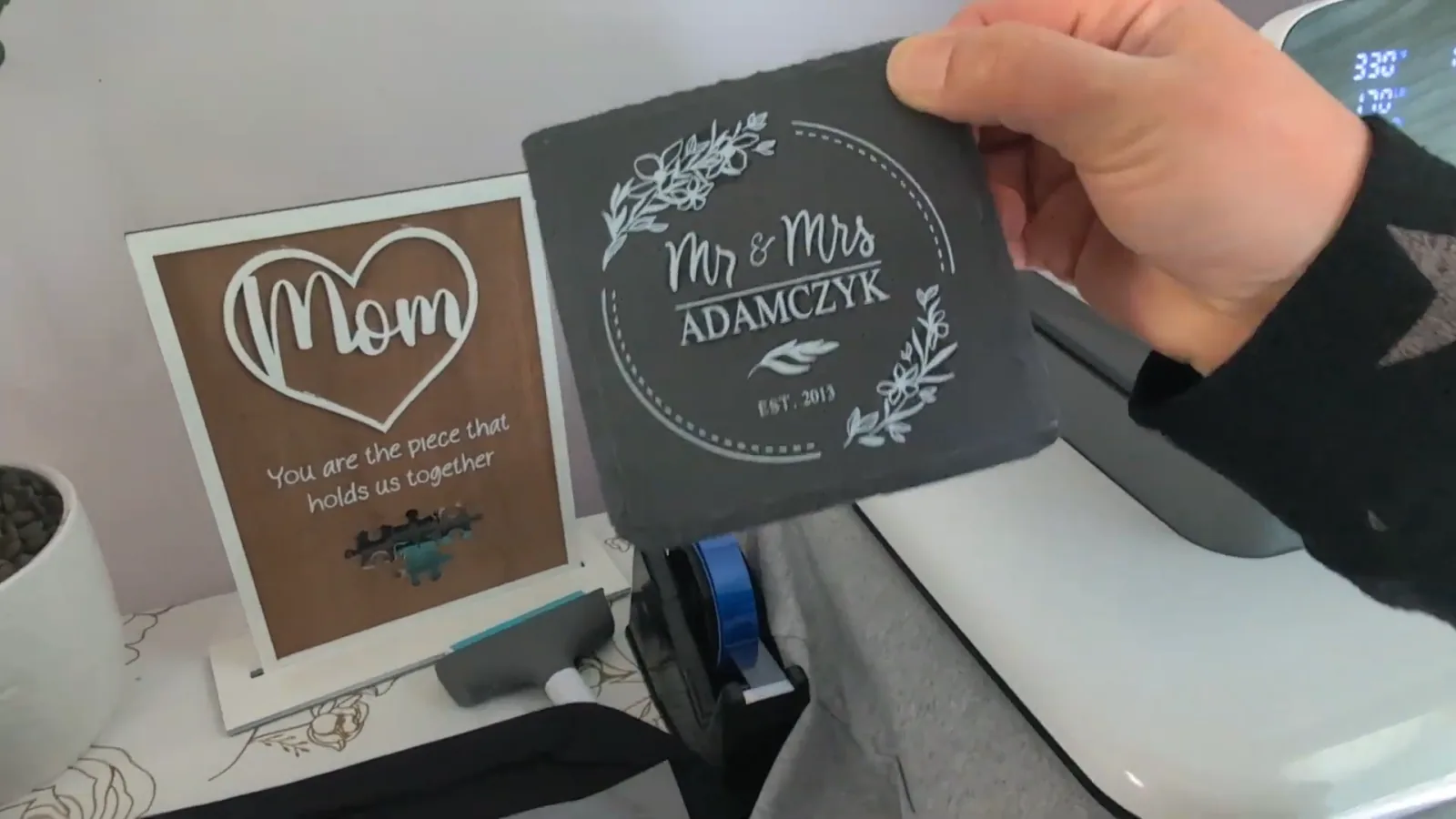 DTF designs printed onto slate coasters and a wooden sign, showing DTF on hard surfaces