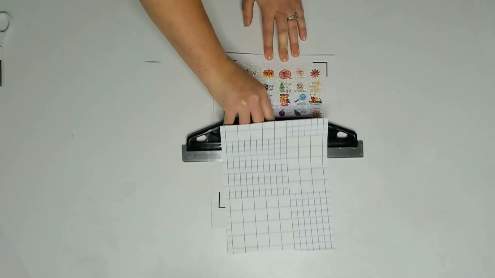 Applying holographic laminate film to a printed sticker sheet, kept inside the black registration marks