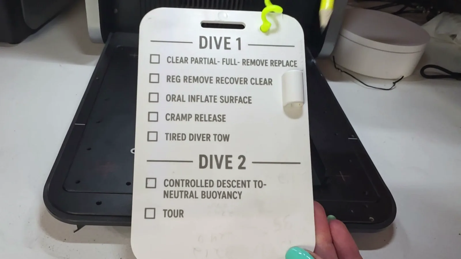 Plastic scuba diving slate engraved with a dive skills checklist using the WeCreat Lumos Ultra UV laser
