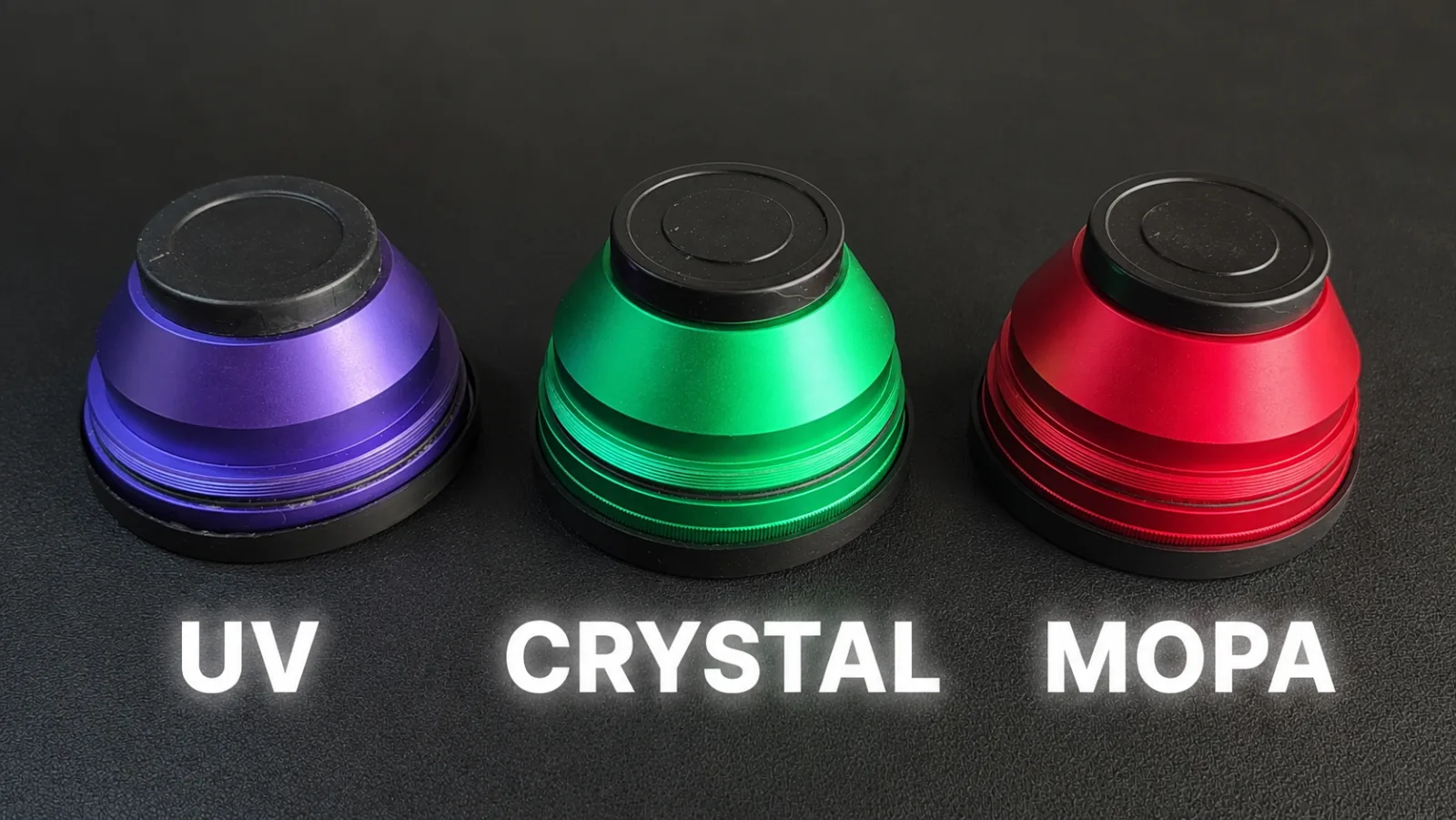 The three color coded WeCreat Lumos Ultra lenses side by side, purple for UV, green for crystal and red for MOPA metal engraving