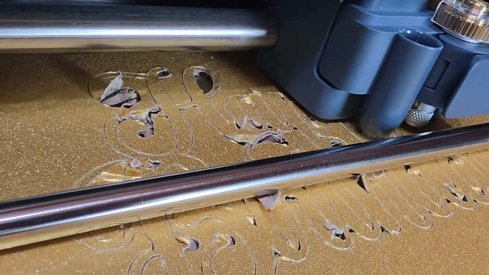 Cricut Knife Blade in a Maker 5 over a gold glitter cake board that shredded instead of cutting cleanly