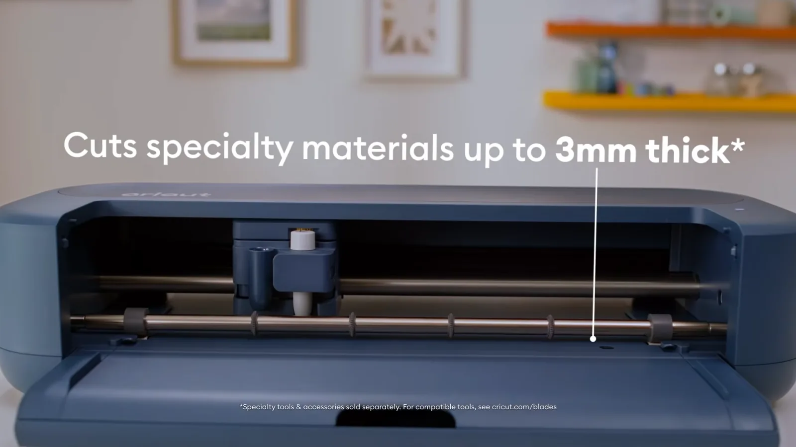 Open Cricut Maker 5 showing the tool carriage with text reading cuts specialty materials up to 3mm thick