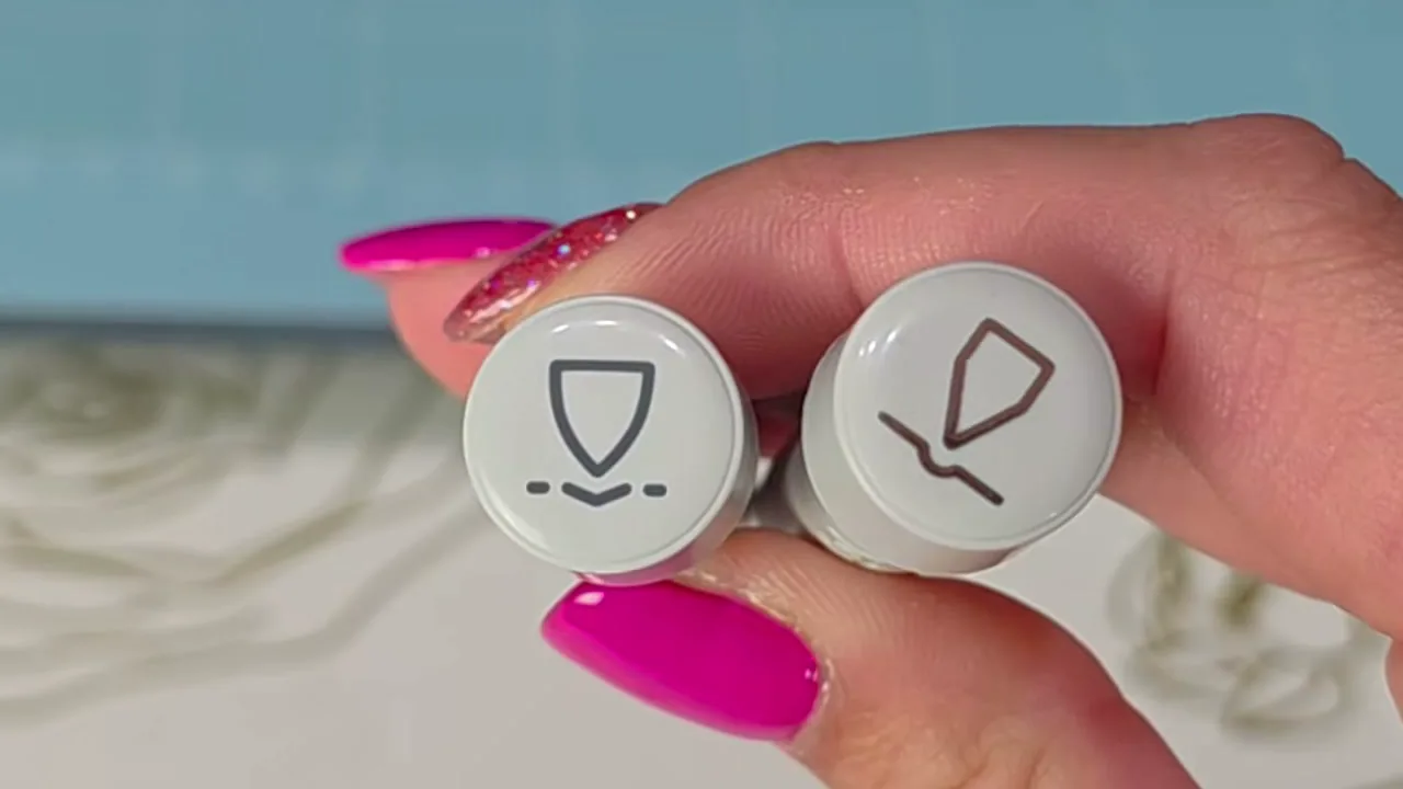 Cricut Scoring Tool and Engraving Tip held side by side, showing their nearly identical caps and symbols