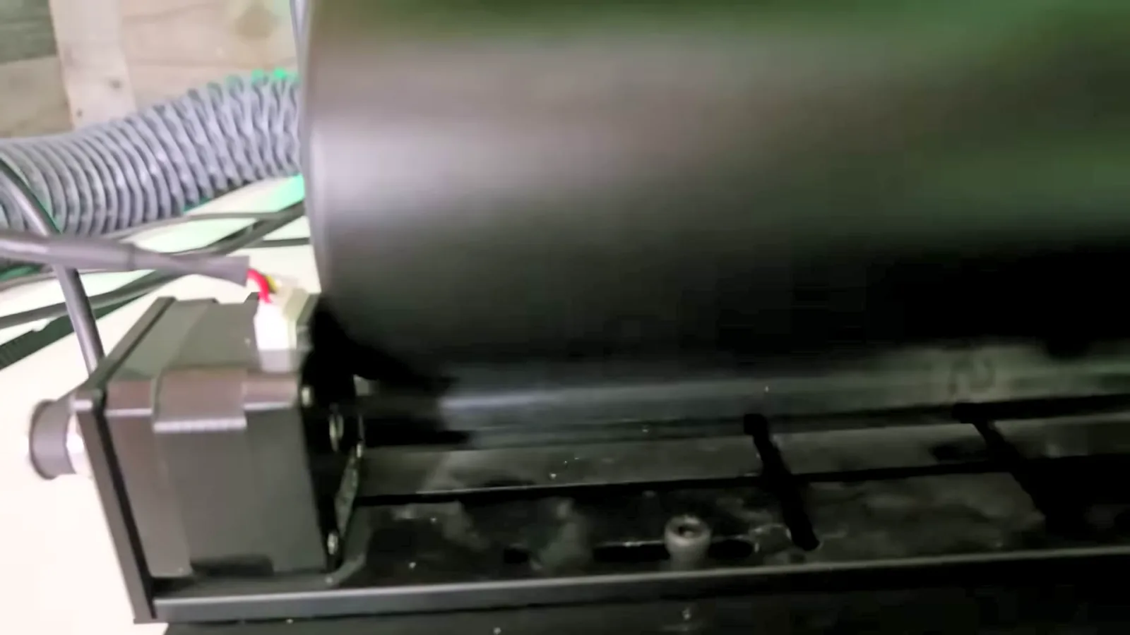 Tumbler seated on the R5 rotary roller with its base against the roller motor for consistent batch engraving