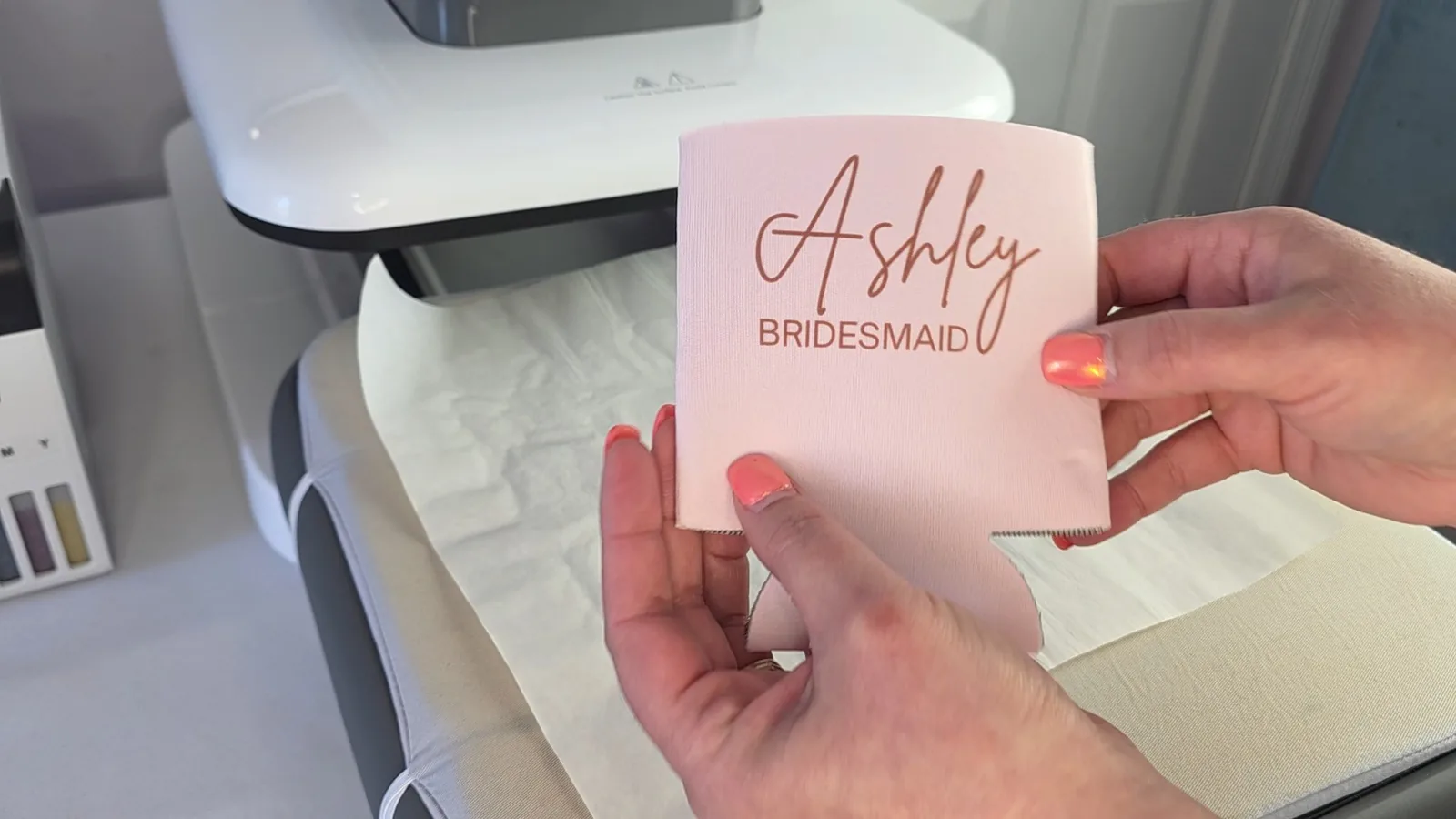 Wedding Sublimation Ideas: 3 Personalized Name Projects That Sell 10 Hand holding a hot sublimated can cooler next to the heat press, where fingers can dent the foam