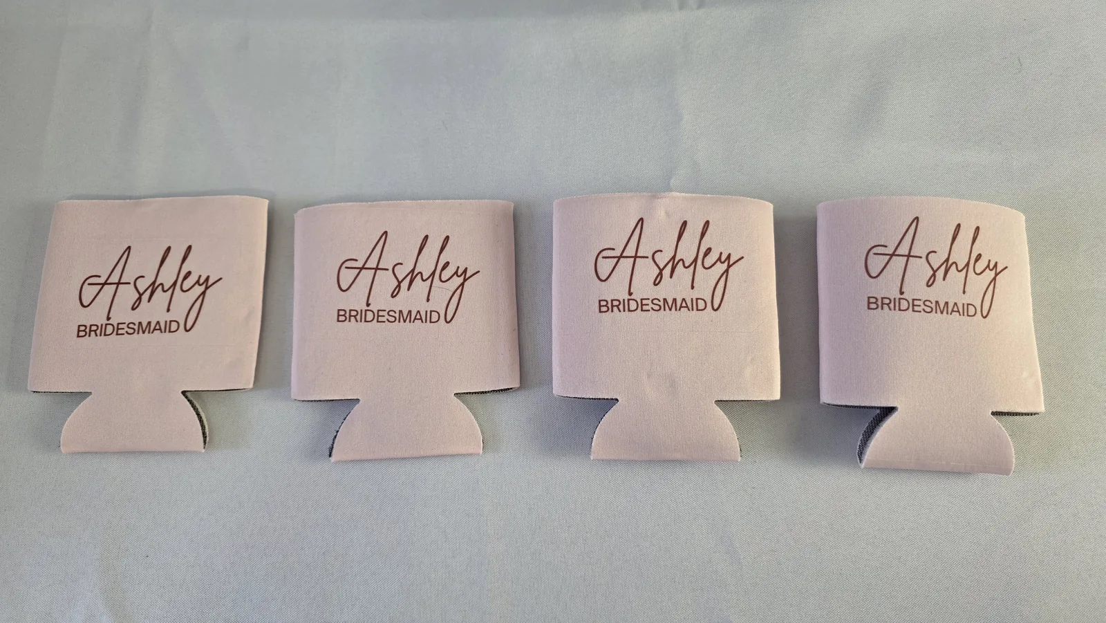 Wedding Sublimation Ideas: 3 Personalized Name Projects That Sell 9 Four sublimated pink can coolers reading Ashley Bridesmaid from repeated test presses