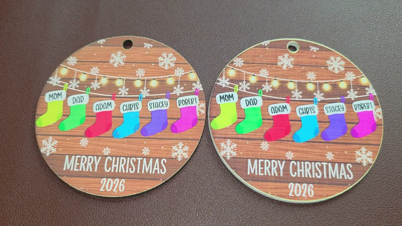 Two ornaments printed on white acrylic coated with white inkAID using the xTool M2, with bright white cut edges